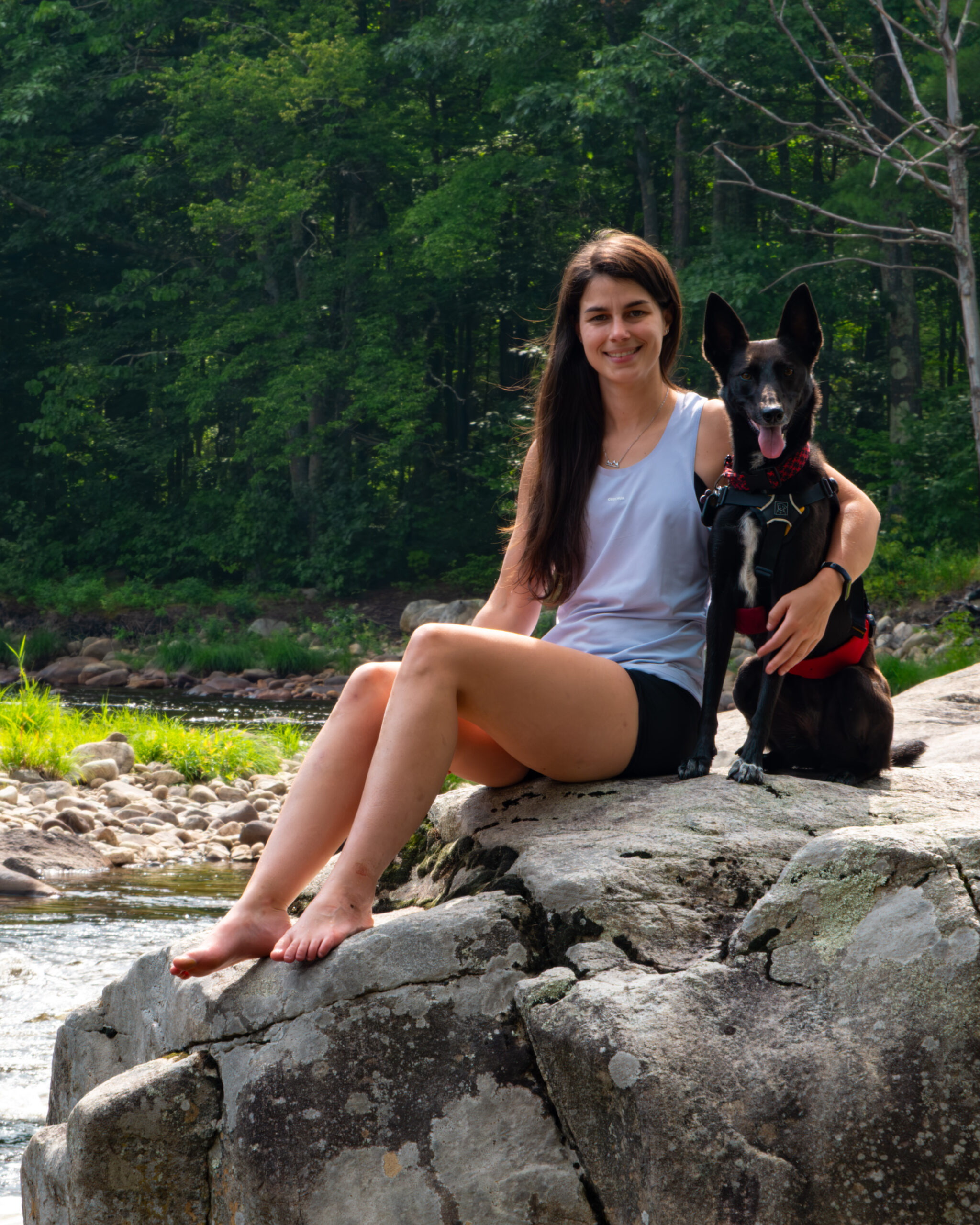 author with her dog by the river