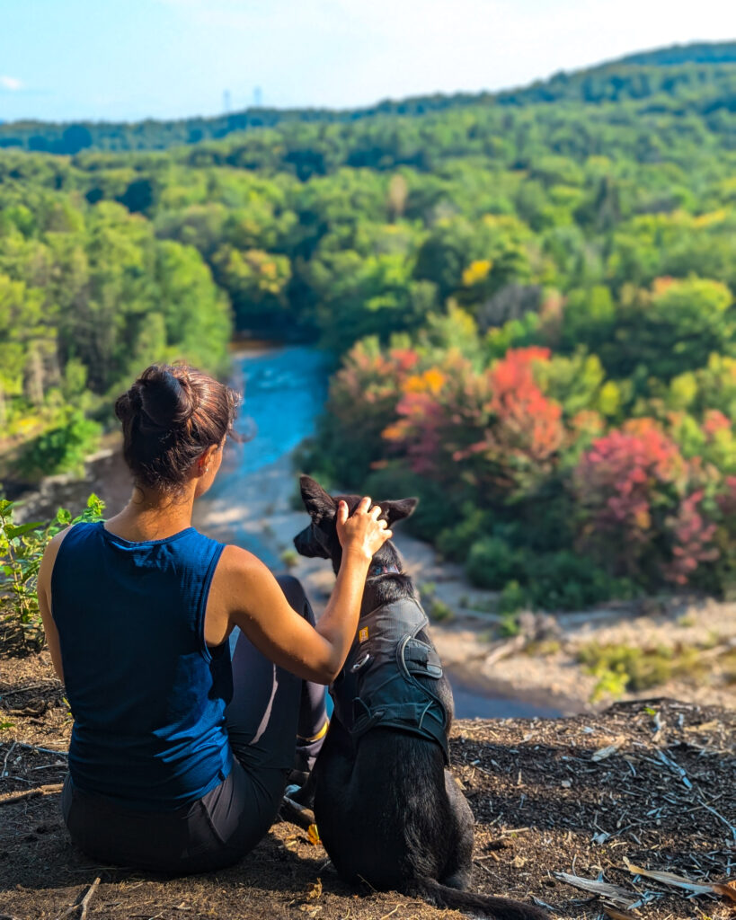 author with her dog on a ledge